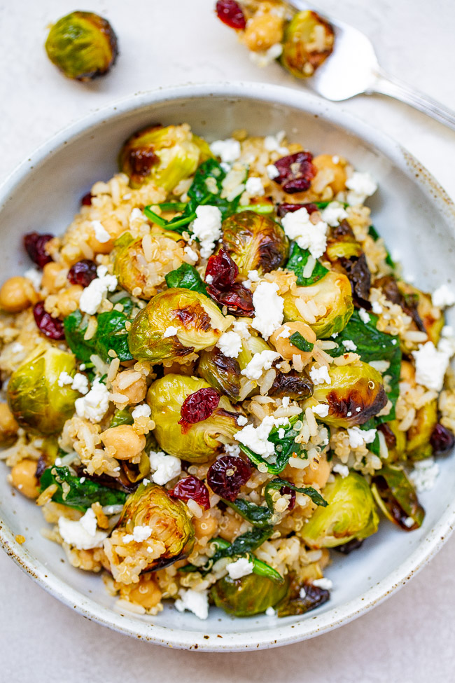 Roasted Brussels Sprouts Salad — A HEARTY salad that celebrates the flavors of fall including roasted Brussels sprouts and dried cranberries along with quinoa, chickpeas, spinach, and goat cheese!! Perfect for lunch, a meatless main, or a HEALTHY side dish on your holiday table!!