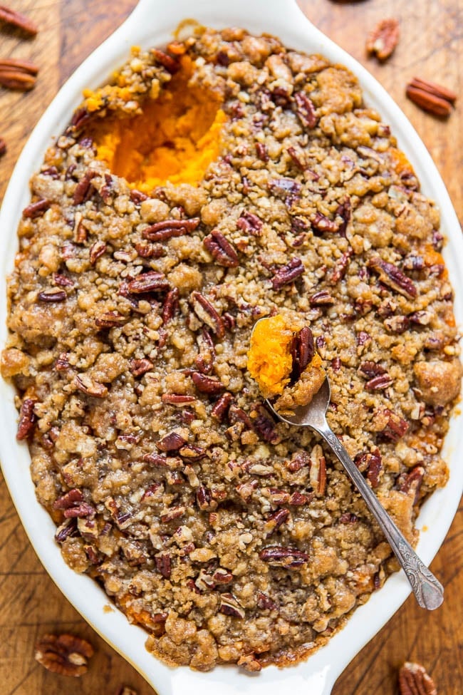 sweet potato casserole with pecan topping in white baking dish