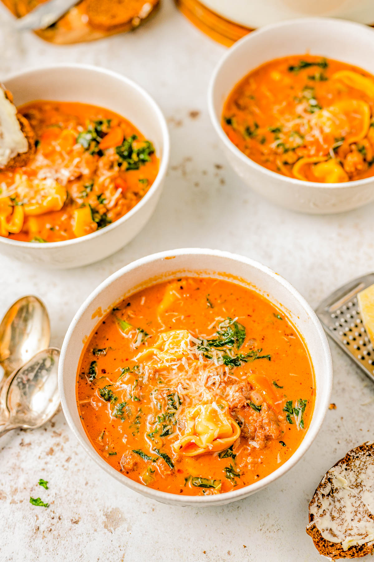 Sausage Tortellini Soup - Indulge in the warmth and coziness of this EASY Italian sausage tortellini soup that's made in one pot and ready in 30 MINUTES! Made with cheesy tortellini, juicy sausage, carrots and kale for extra nutrients, and a rich and creamy tomato sauce broth! This comfort food soup recipe is perfect for chilly weather and you can make it on busy weeknights because it's so QUICK!