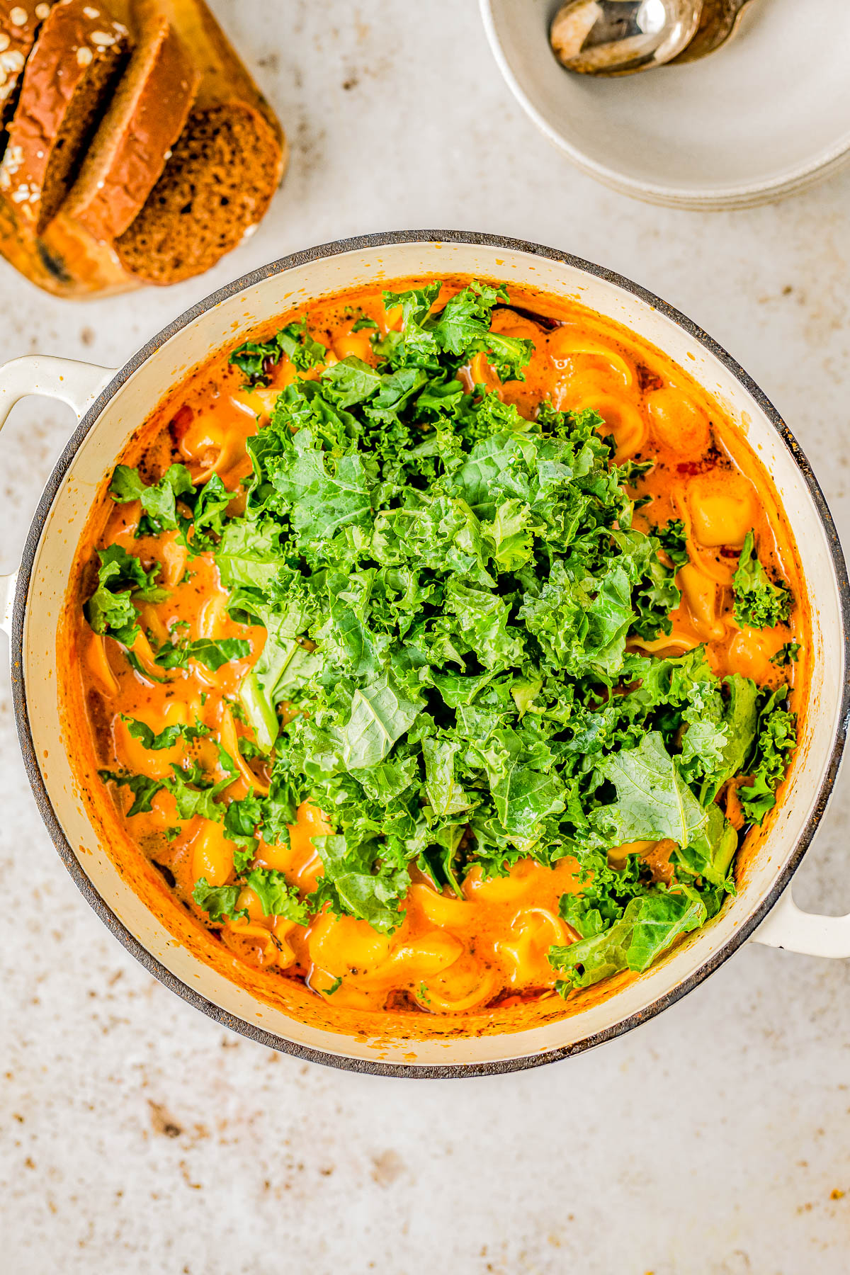 Sausage Tortellini Soup - Indulge in the warmth and coziness of this EASY Italian sausage tortellini soup that's made in one pot and ready in 30 MINUTES! Made with cheesy tortellini, juicy sausage, carrots and kale for extra nutrients, and a rich and creamy tomato sauce broth! This comfort food soup recipe is perfect for chilly weather and you can make it on busy weeknights because it's so QUICK!