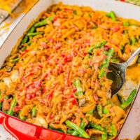Smothered Bacon Green Bean Casserole in a casserole dish with a spoon sticking out.