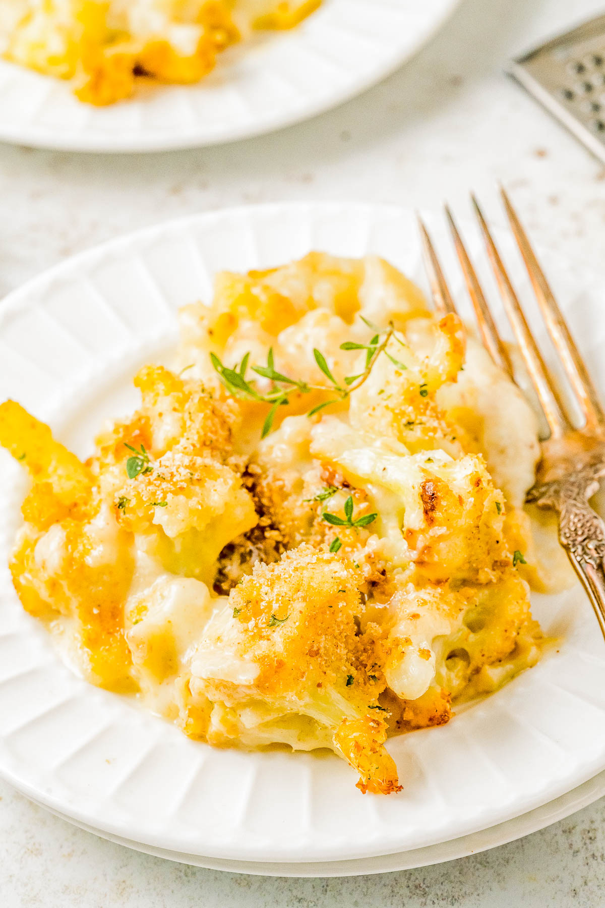 Cheesy Cauliflower Gratin — Cauliflower florets are coated in a creamy cheese sauce and sprinkled with a crispy panko breadcrumb topping before being baked to golden, bubbly perfection! This is an EASY yet ELEGANT side dish that’s perfect for busy weeknights and holiday meals alike including Thanksgiving, Christmas, or New Year's Eve! 