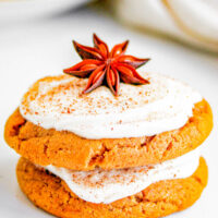 Two chewy ginger molasses cookies with eggnog frosting.