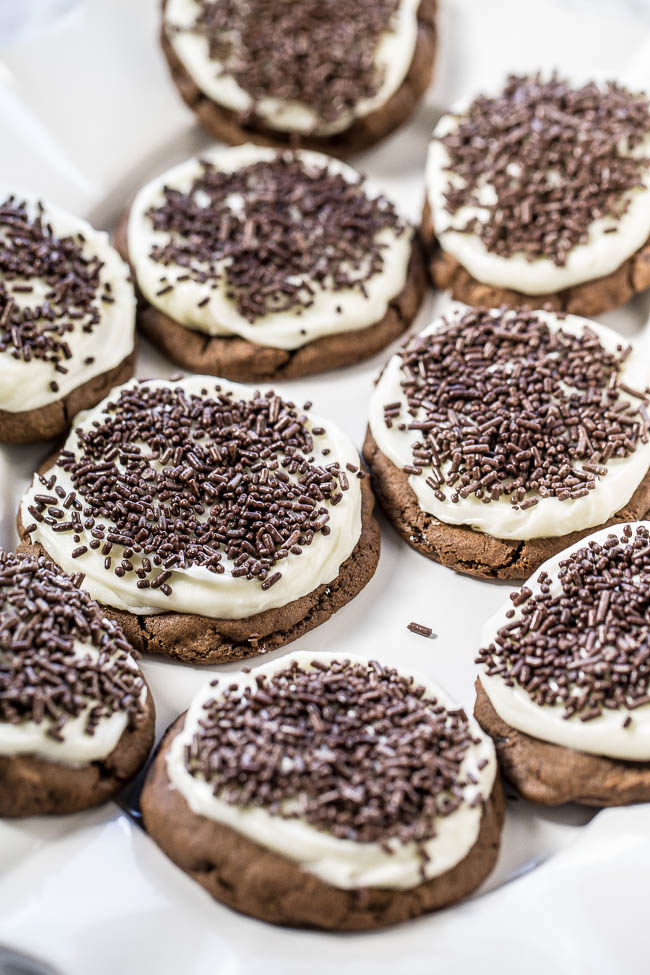 Soft Frosted Double Chocolate Cookies — Soft, chewy, double chocolate cookies topped with tangy cream cheese frosting!! A match made in heaven! And everything's better with sprinkles!!