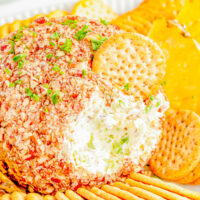 Pineapple Cheese Ball - An EASY holiday appetizer recipe that's a party favorite! Made with tangy cream cheese, juicy pineapple, green bell peppers, green onions, and plenty of nuts for lovely crunch and texture! It's a super simple dump-and-stir recipe with no baking, no cooking, no mixer, and no fuss! Serve this at Christmas parties, New Year's Eve, Super Bowl, and any time you need a guaranteed winner!
