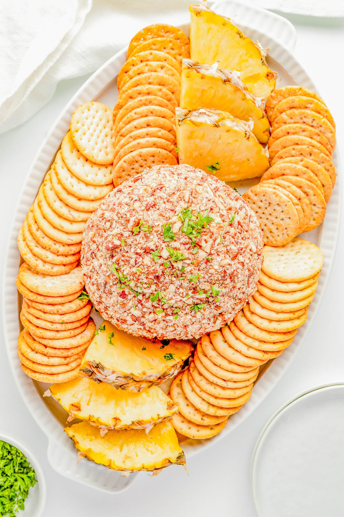 Pineapple Cheese Ball - An EASY holiday appetizer recipe that's a party favorite! Made with tangy cream cheese, juicy pineapple, green bell peppers, green onions, and plenty of nuts for lovely crunch and texture! It's a super simple dump-and-stir recipe with no baking, no cooking, no mixer, and no fuss! Serve this at Christmas parties, New Year's Eve, Super Bowl, and any time you need a guaranteed winner! 