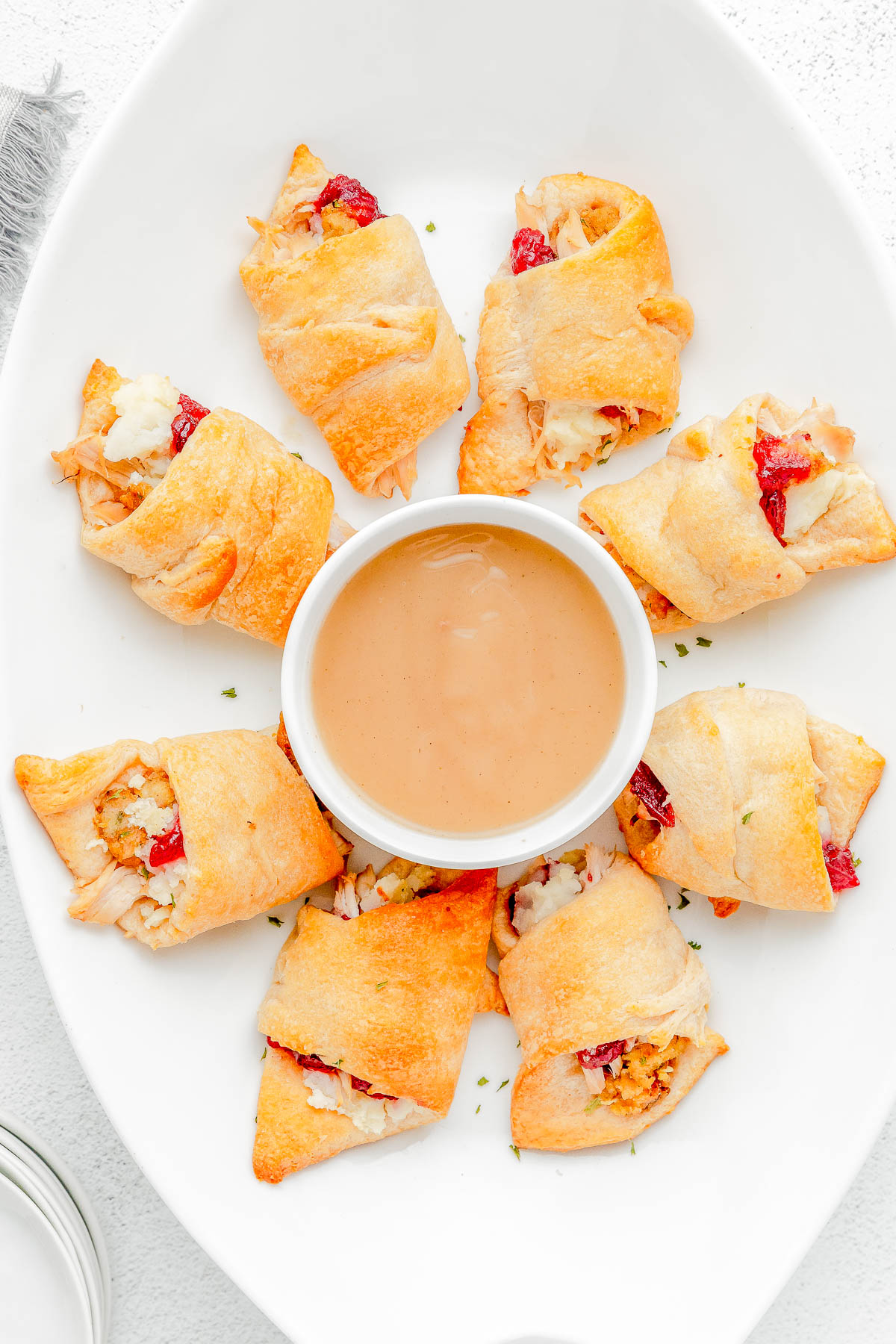 Thanksgiving Leftovers Turkey Crescent Rolls — Looking for a recipe to use a variety of your Thanksgiving leftovers? These stuffed crescent rolls are QUICK and EASY to make using leftovers from your Thanksgiving dinner including turkey, stuffing, mashed potatoes, and gravy! It’s a flexible recipe so feel free to use the leftovers you have on hand to make these crescent roll rollups.