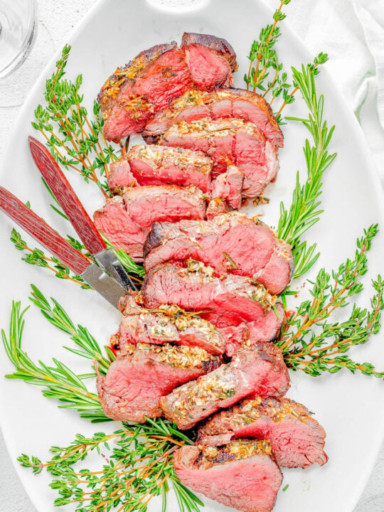 Easy Beef Tenderloin Roast with Garlic Herb Butter — An EASY yet IMPRESSIVE dish that’s ready in under an hour! Roasting beef tenderloin in the oven results in perfectly MOIST and TENDER meat every time, and the garlic herb butter adds tons of flavor without overwhelming the beef. If cooking beef tenderloin intimidates you, follow this straightforward recipe!   