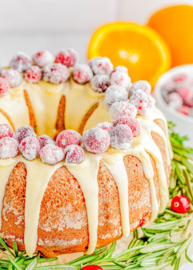 Cranberry Orange Bundt Cake — An elegant yet EASY Bundt cake recipe that only looks like you spent hours on it! This moist and tender cake is flavored with fragrant orange zest, studded with fresh cranberries, and topped with a sweet orange glaze and sugared cranberries! Learn how to make this no-mixer, festive, beautiful dessert that’s PERFECT for any holiday gathering! 