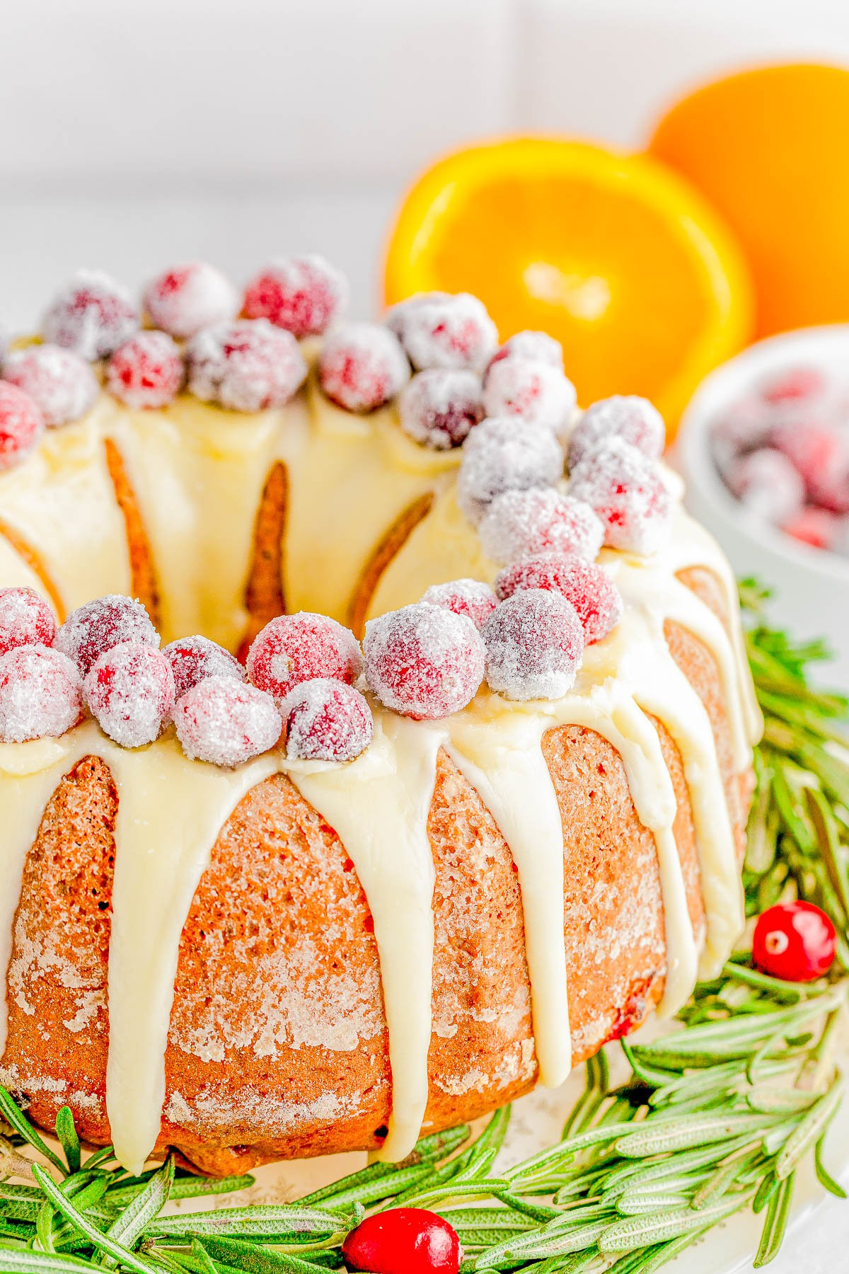 Cranberry Orange Bundt Cake — An elegant yet EASY Bundt cake recipe that only looks like you spent hours on it! This moist and tender cake is flavored with fragrant orange zest, studded with fresh cranberries, and topped with a sweet orange glaze and sugared cranberries! Learn how to make this no-mixer, festive, beautiful dessert that’s PERFECT for any holiday gathering! 