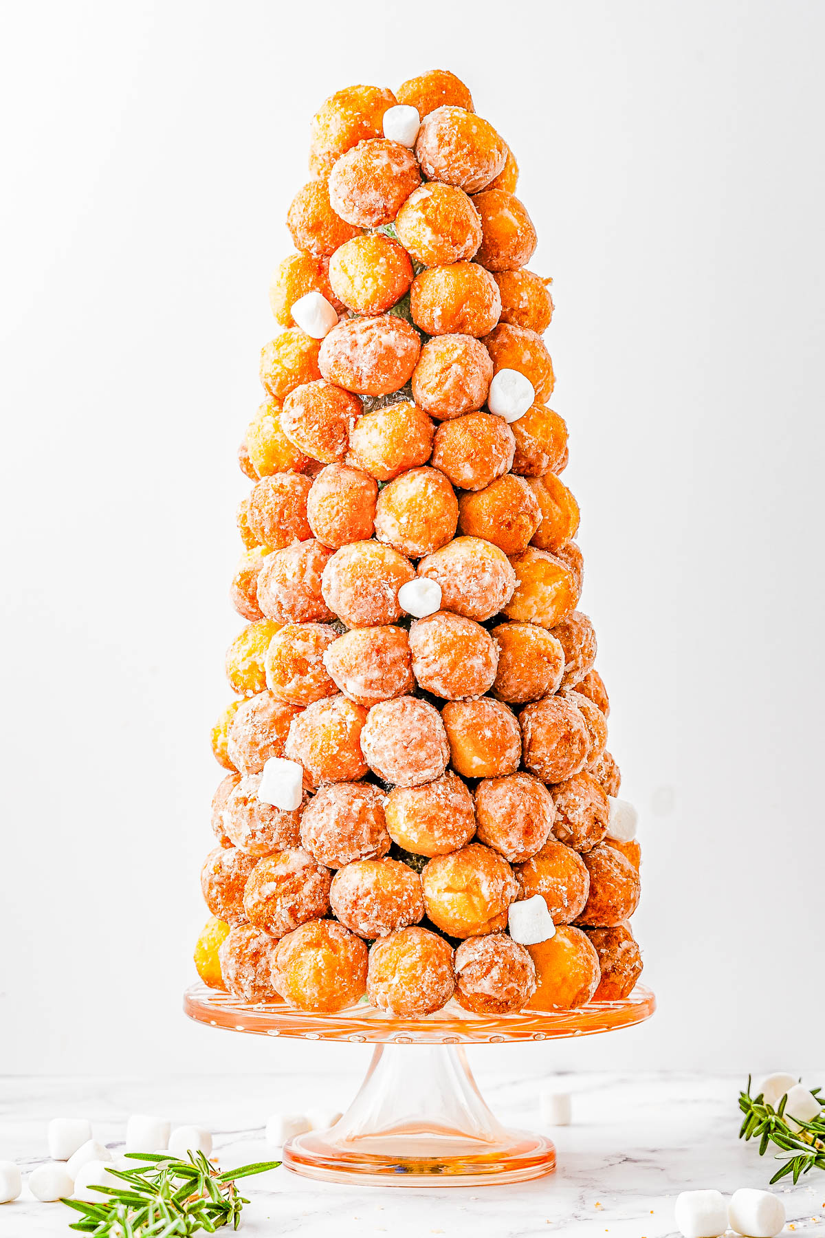 Donut Hole Christmas Tree — Looking for a QUICK and EASY, yet FESTIVE centerpiece for your holiday dessert table or brunch spread? Try making a Christmas tree out of donut holes! All you need is a styrofoam cone from the craft store and some store-bought donut holes. Decorate your tree however you want, then let guests help themselves!   
