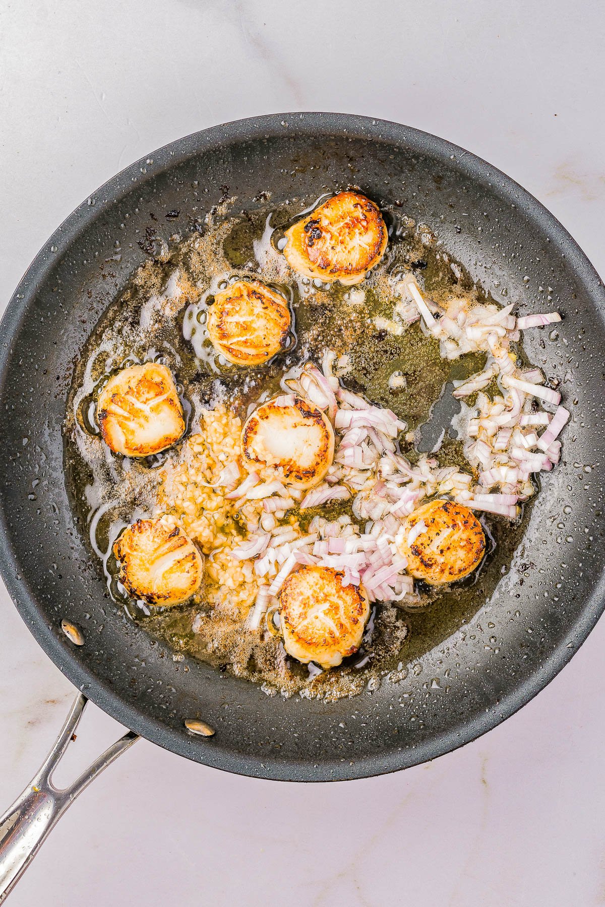 Garlic Butter Scallops - An EASY, one-skillet, 15-minute recipe that tastes restaurant-worthy, yet is incredibly SIMPLE to make at home! Even if you've never made scallops at home before, this is a foolproof recipe for pan-seared, tender, juicy scallops coated in garlic butter with lemon and citrus notes that's sure to IMPRESS! A wonderful choice for a special holiday meal, an anniversary or birthday dinner, or date-night-in! 