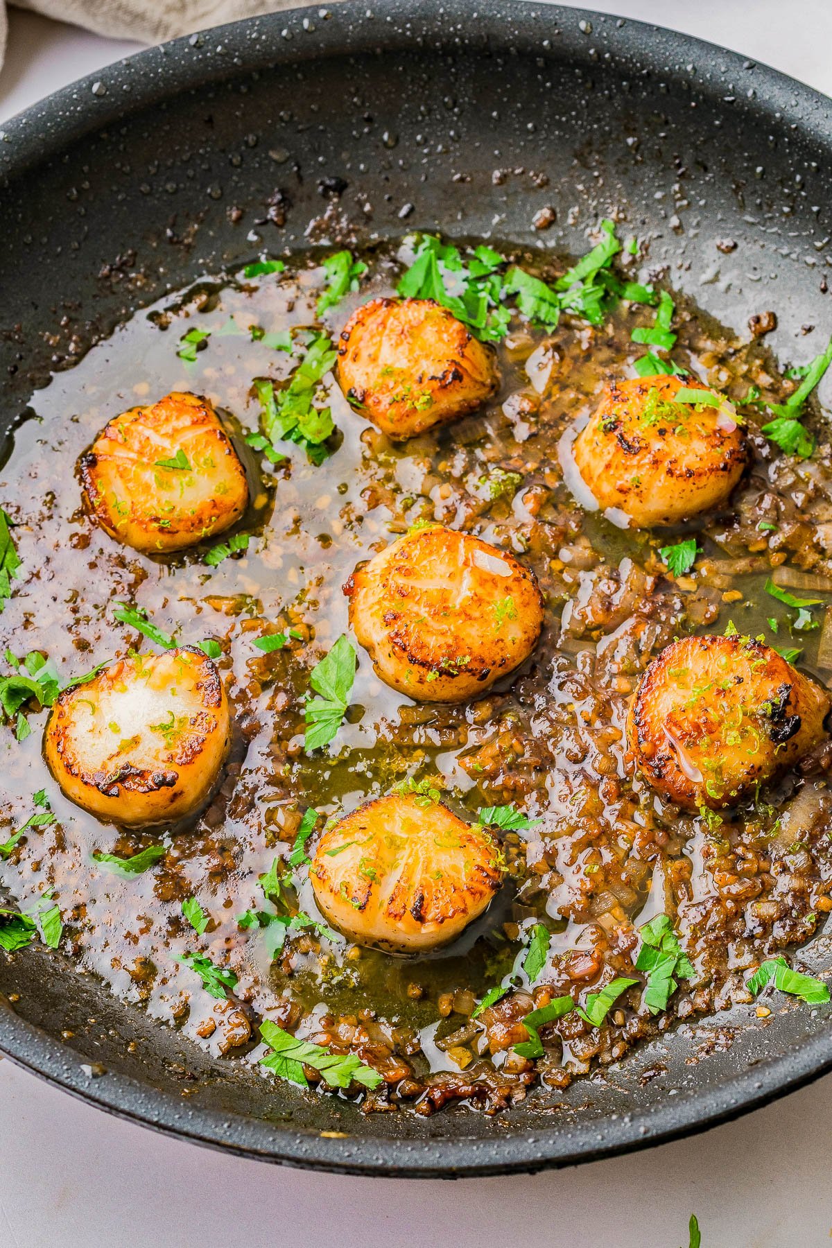 Garlic Butter Scallops - An EASY, one-skillet, 15-minute recipe that tastes restaurant-worthy, yet is incredibly SIMPLE to make at home! Even if you've never made scallops at home before, this is a foolproof recipe for pan-seared, tender, juicy scallops coated in garlic butter with lemon and citrus notes that's sure to IMPRESS! A wonderful choice for a special holiday meal, an anniversary or birthday dinner, or date-night-in! 