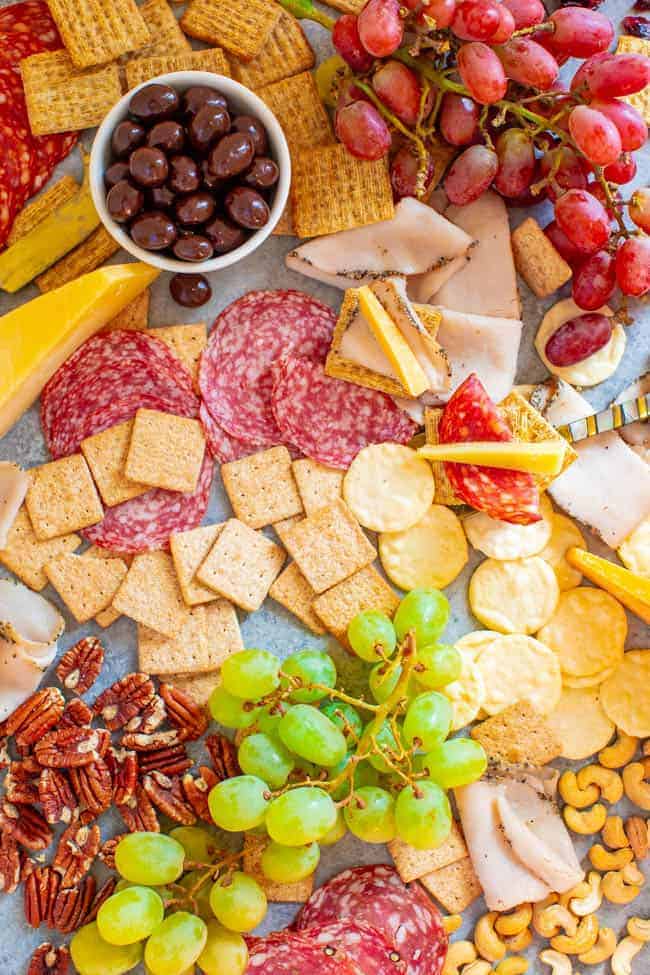 Girls Night Charcuterie Board - A SALTY-SWEET mix of meats, cheeses, fruit, chocolate almonds, Triscuits, Wheat Thins, Good Thins, and more for your next GIRLS-NIGHT-IN!! There's something for everyone on this EASY-TO-ASSEMBLE board!!