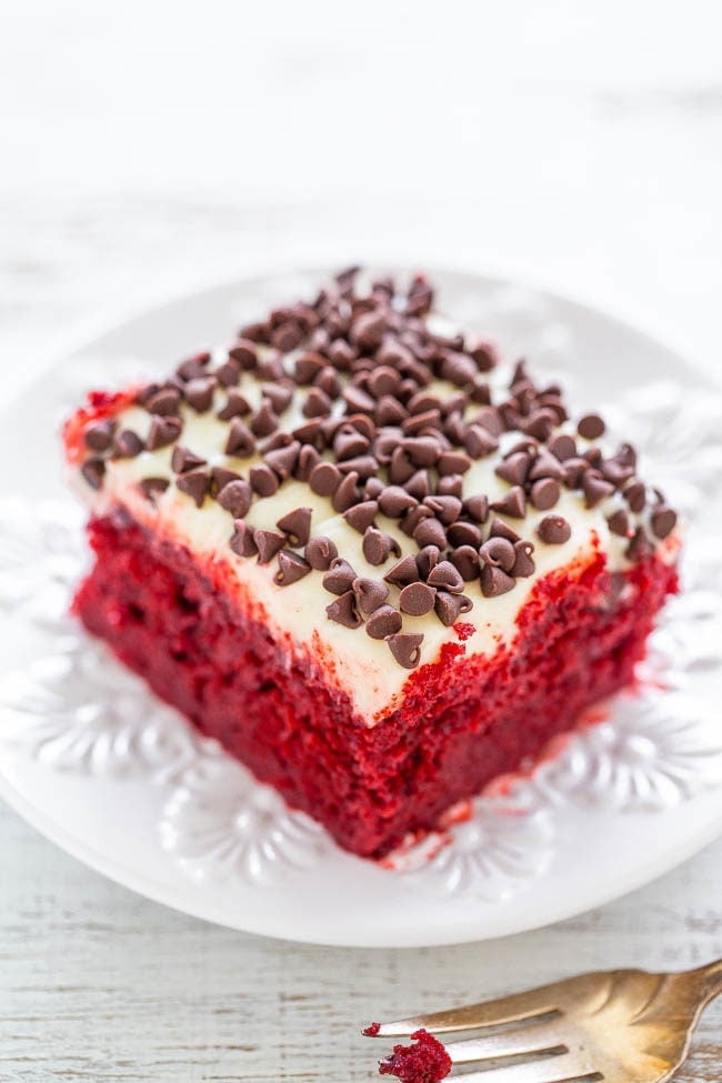 Red Velvet Poke Cake with Cream Cheese Frosting - If you like red velvet, you're going to LOVE this EASY cake!! Super soft, moist, topped with luscious cream cheese frosting and chocolate chips! Perfect for holidays and special events!!