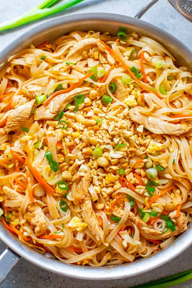 Chicken Pad Thai - EASY, ready in 20 minutes, and BETTER than takeout!! Tender rice noodles, juicy chicken, with crisp-tender carrots, cabbage, and more for an IRRESISTIBLE and AUTHENTIC chicken pad Thai!! 