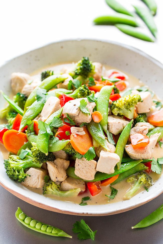 Thai Coconut Chicken Stir Fry - Chicken, sugar snap peas, bell peppers, and carrots simmered in a rich coconut milk broth that's irresistible!! Layers of flavor, EASY, ready in 20 MINUTES, and HEALTHY!!
