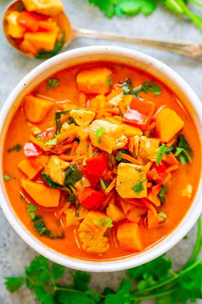 Thai Coconut Curry Chicken Soup - EASY, ready in 30 minutes, HEALTHY, and loaded with FLAVOR!! The sweet potatoes, carrots, red peppers, chicken, spinach, cilantro, and coconut milk broth combine to form an AMAZING soup!!