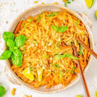 15-Minute Spicy Peanut Noodles - Drenched in spicy peanut sauce, this EASY recipe for peanut noodles is faster than calling for takeout! Homemade peanut sauce is amped up with sesame oil, ginger, soy, sriracha, and tossed with rice noodles for a great quick and easy lunch or busy weeknight dinner. Vegetarian and gluten-free comfort food that'll keep you satisfied for hours! Adding your favorite protein is always welcome.