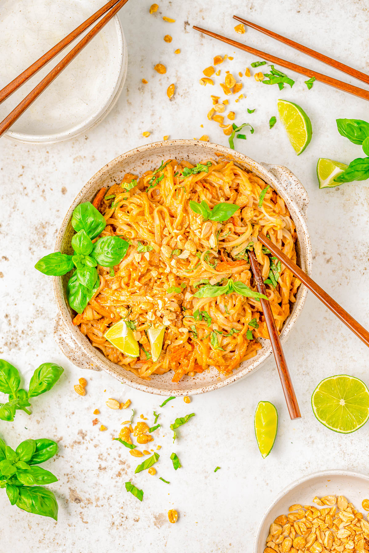 15-Minute Spicy Peanut Noodles - Drenched in spicy peanut sauce, this EASY recipe for peanut noodles is faster than calling for takeout! Homemade peanut sauce is amped up with sesame oil, ginger, soy, sriracha, and tossed with rice noodles for a great quick and easy lunch or busy weeknight dinner. Vegetarian and gluten-free comfort food that'll keep you satisfied for hours! Adding your favorite protein is always welcome.