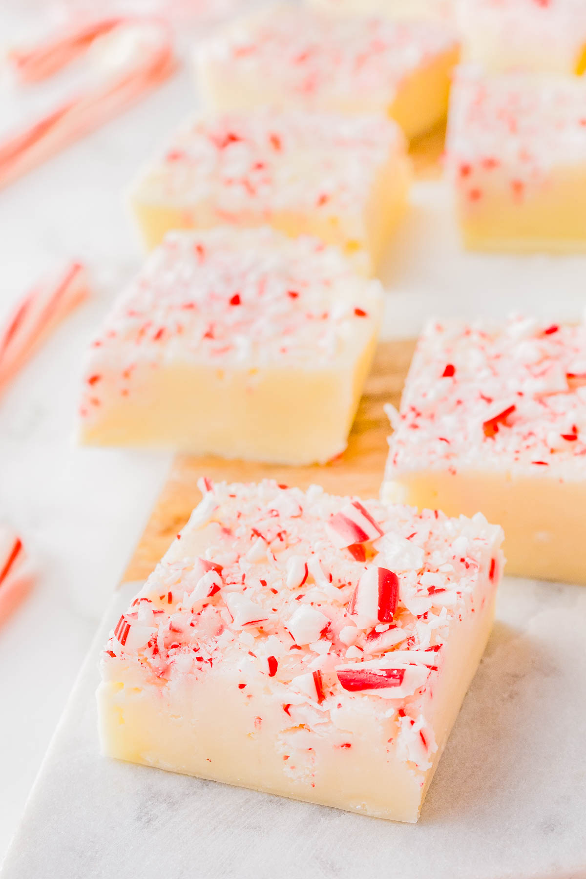 White Chocolate Peppermint Fudge - A FOOLPROOF recipe for fudge with no boiling, no candy thermometers, and it turns out PERFECTLY every time! This EASY recipe uses just 4 INGREDIENTS, can be made ahead of time, and is great for holiday entertaining! It's creamy and rich with a peppermint crunch, making it a wonderfully festive treat!