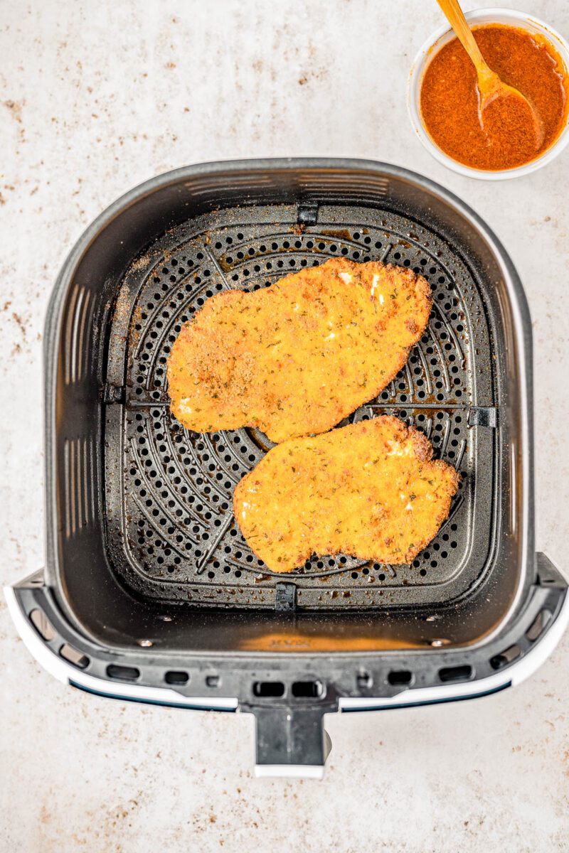 Air Fryer Hot Honey Chicken — Breaded chicken cutlets are air fried until crispy, then drizzled with spicy-sweet hot honey! This is such a QUICK and EASY air fryer chicken recipe that takes less than 30 minutes to prepare! Oven-baking instructions are also provided.