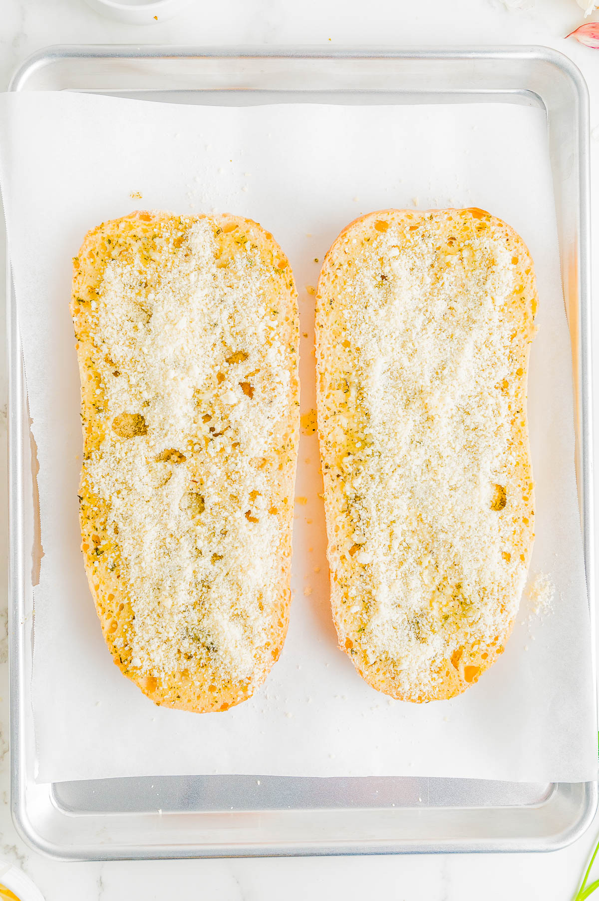 Easy Cheesy Garlic Bread - French bread that's been brushed with melted garlic butter and Italian seasoning, then topped with mounds of mozzarella and Parmesan cheeses, and baked to perfection is what this EASY appetizer, snack, or side is all about! Garlic bread with cheese is a family favorite that no one can resist and ready in just 15 minutes!