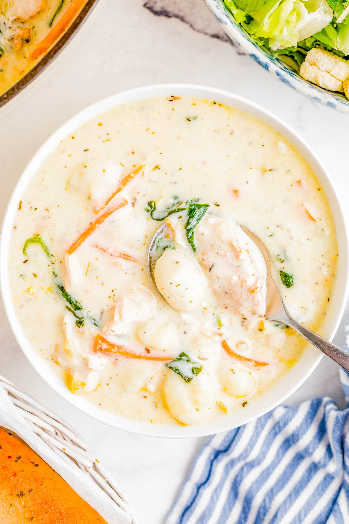 Chicken Gnocchi Soup - This Olive Garden Copycat recipe is so EASY, made in one pot, and ready in just 30 minutes! There's an abundance of chicken and tender gnocchi, along with onions, carrots, and garlic for layers of flavor. Fresh spinach adds texture while the creamy broth makes this the ULTIMATE comfort food soup recipe that the whole family will LOVE! We think it's even BETTER than the restaurant version!