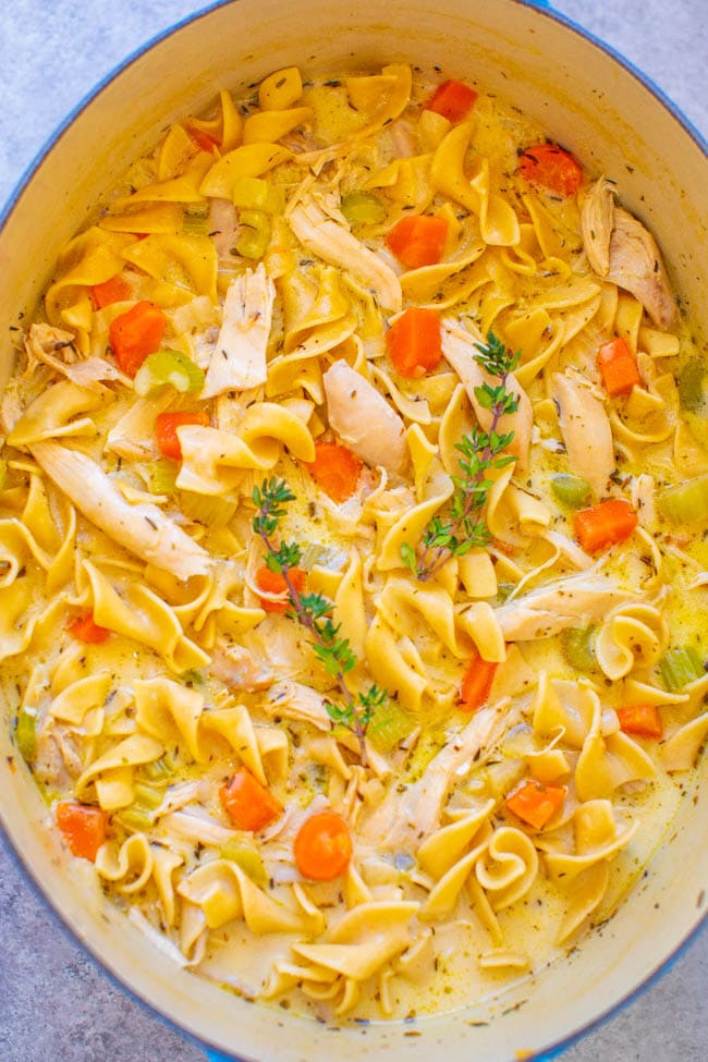 overhead view of creamy chicken noodle soup in a large dutch oven 