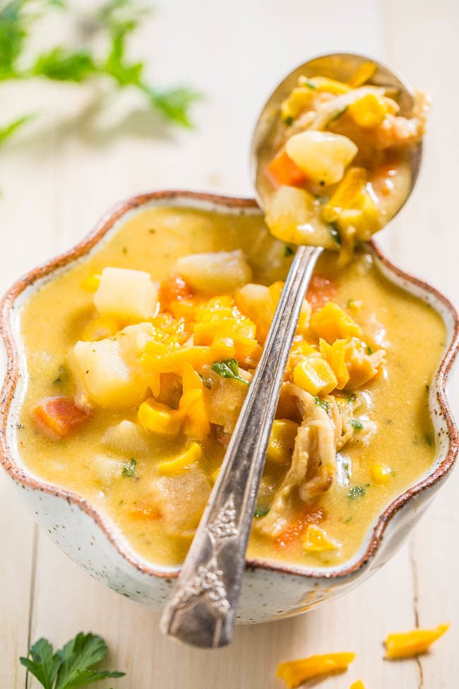 Loaded Cheesy Chicken Potato Chowder - Potatoes, chicken, carrots, corn and more!! Thick, creamy, rich, and wonderfully cheesy!! Fast and easy comfort food that everyone loves!!