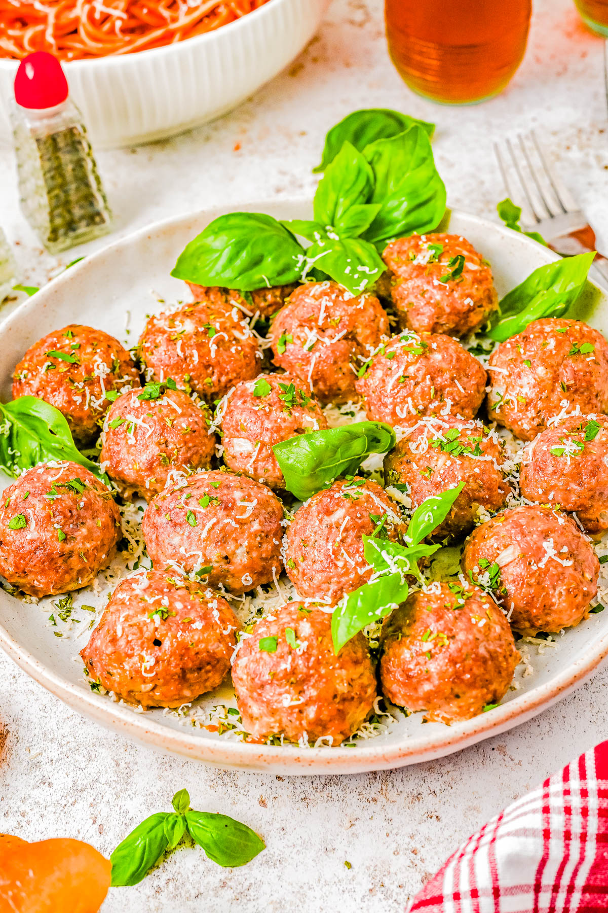 Baked Italian Meatballs — Ready in just 30 minutes, these quick and EASY baked meatballs come out perfectly moist and tender every time! There’s no need to brown the meatballs before baking, which cuts back on dishes and saves time! These are the BEST Italian meatballs for spaghetti, subs, casseroles, and more! 