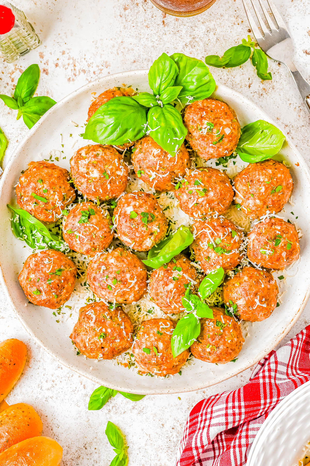 Baked Italian Meatballs — Ready in just 30 minutes, these quick and EASY baked meatballs come out perfectly moist and tender every time! There’s no need to brown the meatballs before baking, which cuts back on dishes and saves time! These are the BEST Italian meatballs for spaghetti, subs, casseroles, and more! 