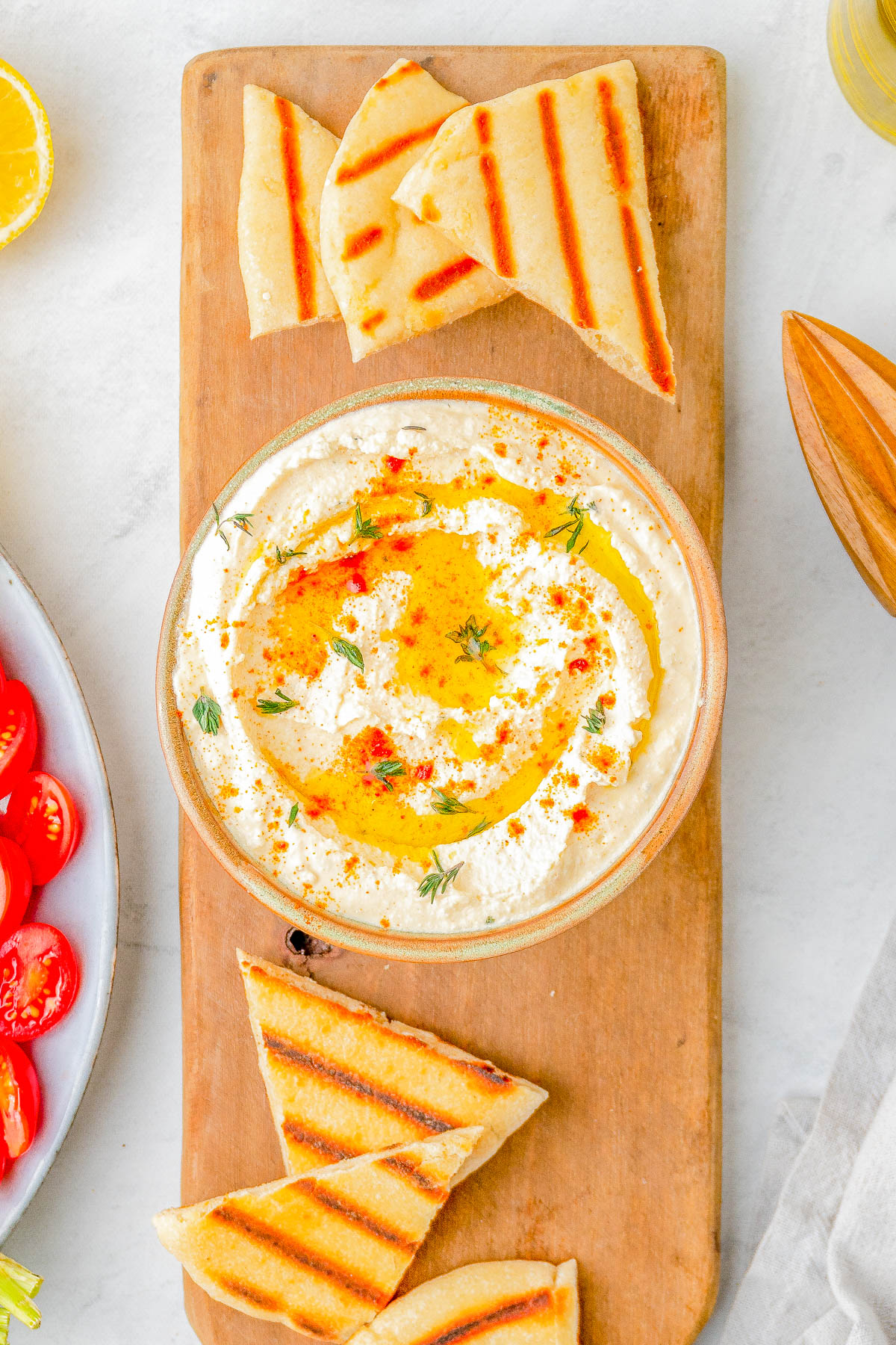 Whipped Feta Dip - Ready in just 5 minutes and made with feta cheese, Greek yogurt, lemon, garlic, olive oil, and a variety of spices, this creamy and EASY dip is a FAVORITE! Just the right amount of tangy-salty-creamy! It's PERFECT for holiday or casual entertaining, game day parties, or summertime backyard get-togethers and everyone will want the recipe!