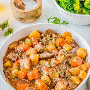 Old-Fashioned Beef Stew — A EASY stovetop recipe that features succulent pieces of beef with tender carrots and potatoes, all coated in a rich gravy! Make this COMFORT FOOD classic all winter long. It’s a simple recipe with minimal ingredients and very little hands on prep that the whole family will adore!