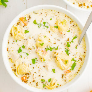 Creamy Chicken Tortellini Soup - Ready in just 30 minutes, and made in one pot, this EASY soup is a comfort food family favorite! Tender chicken, vegetables, and plenty of cheese tortellini in a super rich and creamy broth make this the PERFECT cold weather meal. Simple to make for lunch or busy weeknight dinners because it comes together so quickly!
