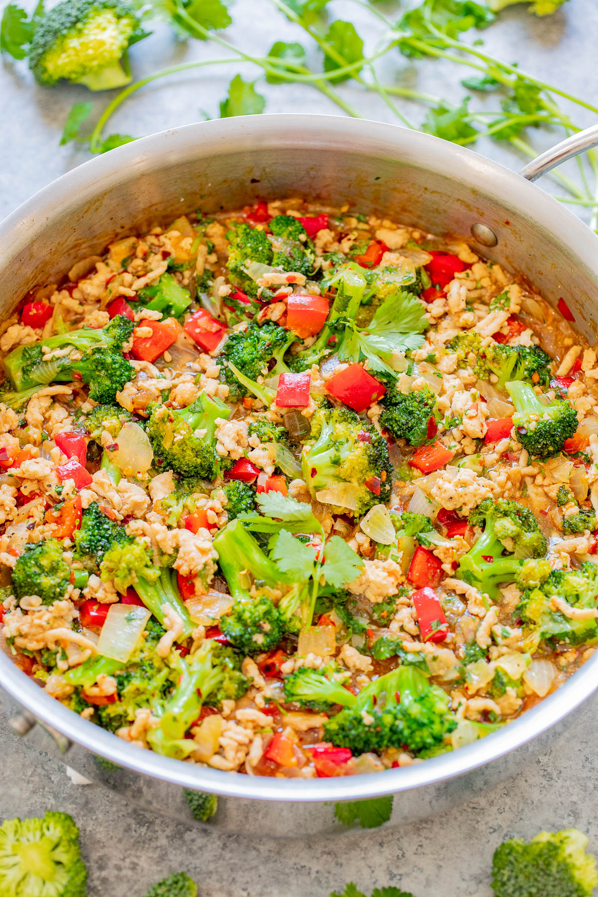 Sweet Chili Ground Chicken and Broccoli Stir Fry - EASY, ready in 30 minutes, made in ONE skillet, and layered with Asian-inspired flavors! Juicy chicken, crisp-tender broccoli, red bell peppers, and more are coated with sweet chili sauce, soy sauce, sesame oil, and finished with fresh cilantro for a pop of freshness! 