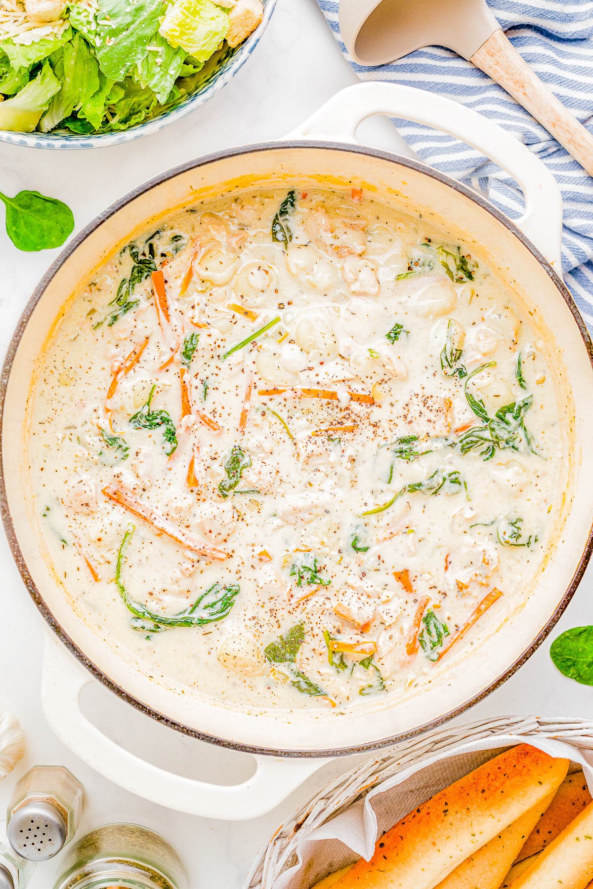 Chicken Gnocchi Soup - This Olive Garden Copycat recipe is so EASY, made in one pot, and ready in just 30 minutes! There's an abundance of chicken and tender gnocchi, along with onions, carrots, and garlic for layers of flavor. Fresh spinach adds texture while the creamy broth makes this the ULTIMATE comfort food soup recipe that the whole family will LOVE! We think it's even BETTER than the restaurant version!