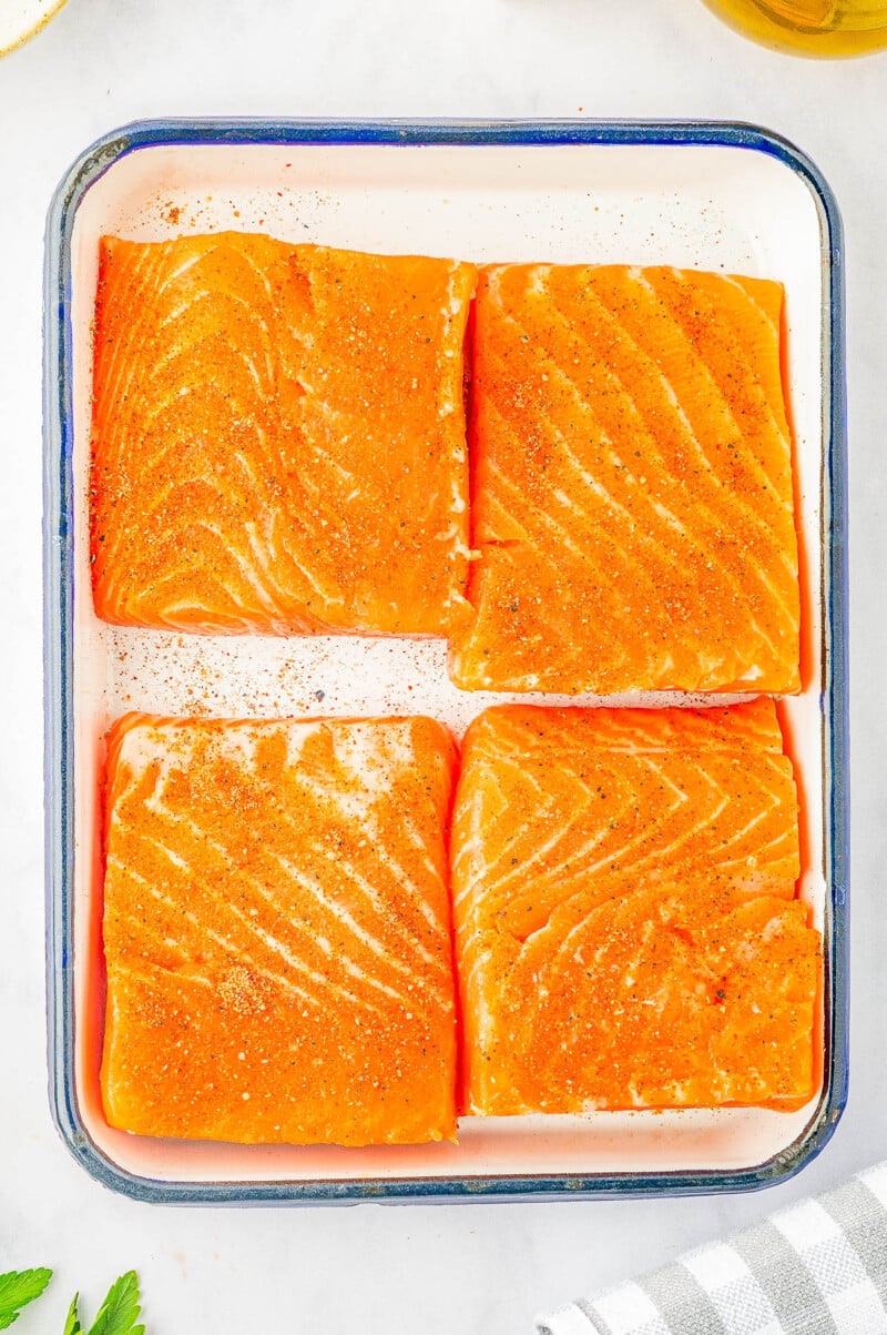 Creamy Garlic Butter Tuscan Salmon - An EASY one-skillet salmon recipe for the most tender and juicy salmon that's bathed in a rich and creamy garlic butter sauce! Parmesan cheese, sun dried tomatoes, and baby spinach add extra flavor and texture to this 30-minute recipe that everyone LOVES! Learn how to make restaurant-worthy salmon that's fast enough for a weeknight dinner but elevated enough to serve to company!