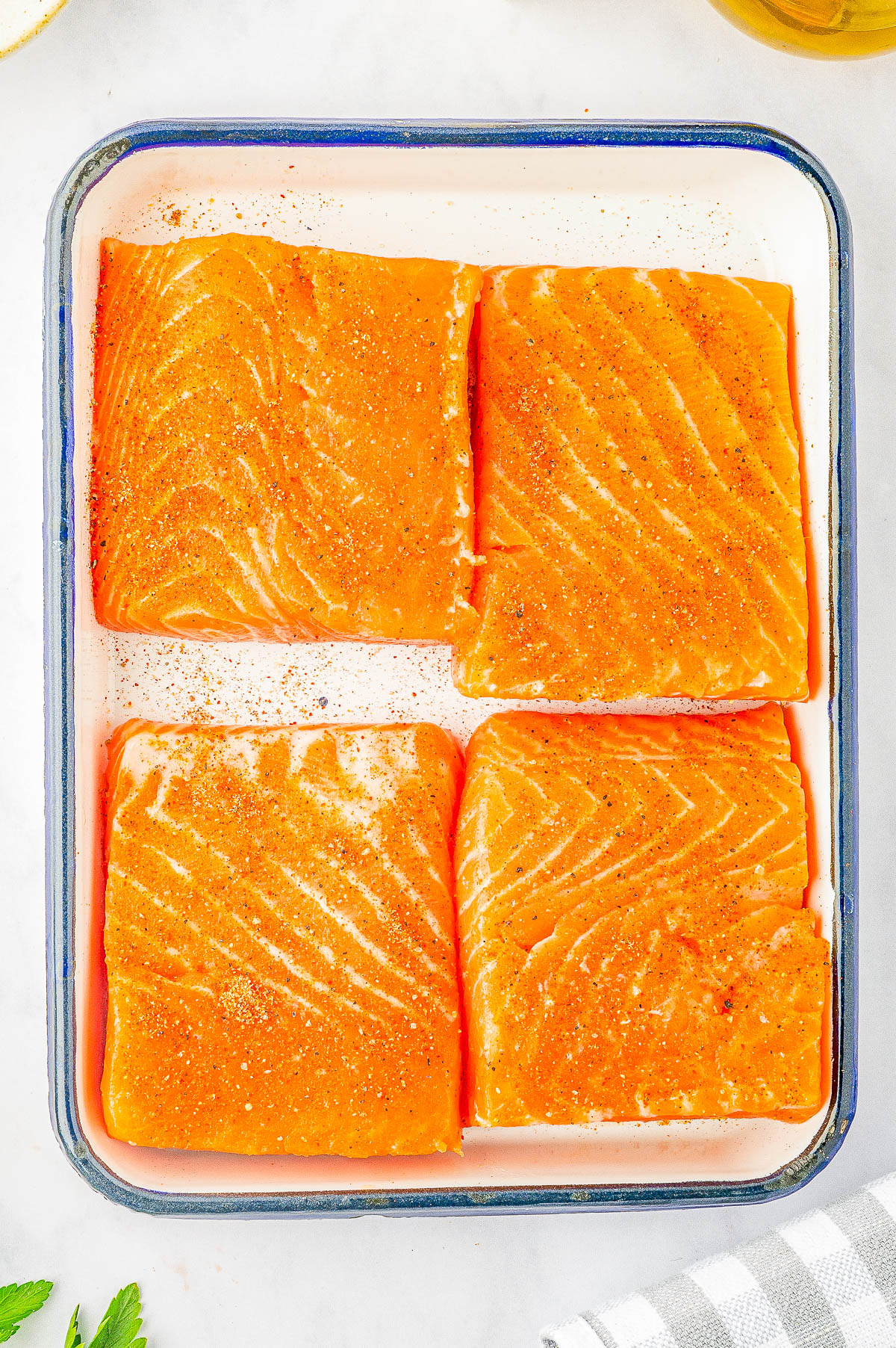 Creamy Garlic Butter Tuscan Salmon - An EASY one-skillet salmon recipe for the most tender and juicy salmon that's bathed in a rich and creamy garlic butter sauce! Parmesan cheese, sun dried tomatoes, and baby spinach add extra flavor and texture to this 30-minute recipe that everyone LOVES! Learn how to make restaurant-worthy salmon that's fast enough for a weeknight dinner but elevated enough to serve to company!