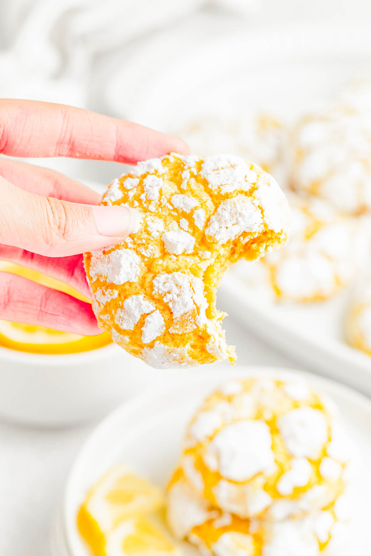 Lemon Crinkle Cookies — Lemon crinkles are pillowy soft on the inside and chewy on the outside, with slightly crispy edges from the powdered sugar coating! They taste like lemon bars, but in cookie form! The dough is flavored with lemon three ways and is perfect for holiday gatherings, Easter, Mother’s day, or whenever you’re craving an EASY lemon dessert 🍋!