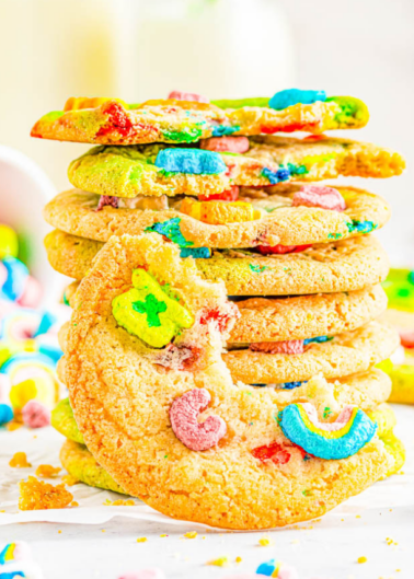A stack of sugar cookies with colorful cereal marshmallows on a light, bright background.