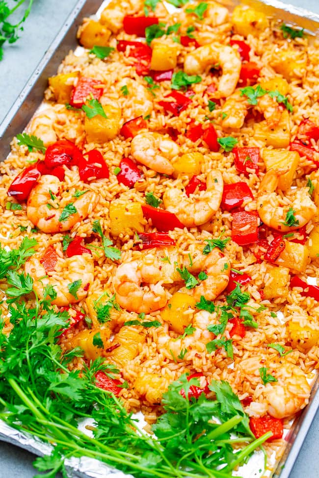 overhead view of sheet pan shrimp, rice, and bell peppers with fresh cilantro on side