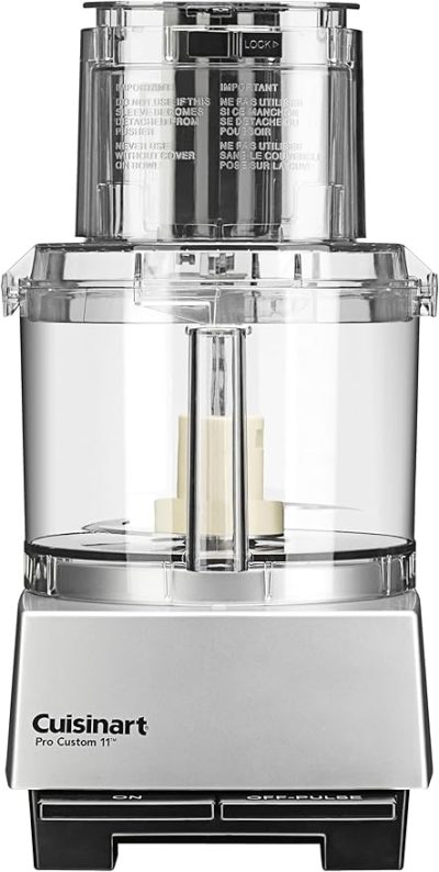 A Cuisinart Pro Custom 11-cup food processor with a clear plastic bowl and lid, set on a silver and black base, featuring on and off/pulse buttons.