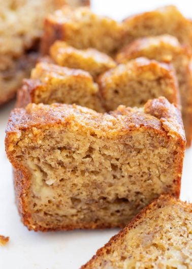 Close-up of sliced banana bread showing a moist, dense texture with visible bits of banana inside.