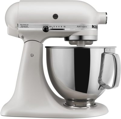 A silver KitchenAid Artisan stand mixer with a stainless steel mixing bowl attached, shown in a side profile on a white background.