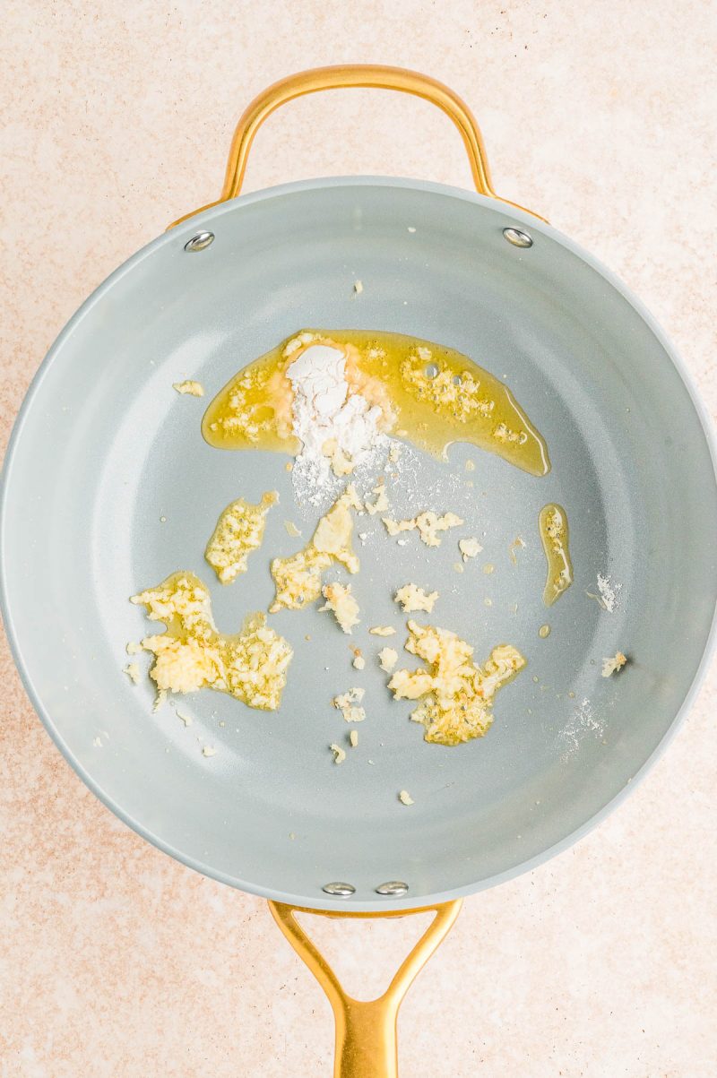 A nonstick pan with melted butter and flour mixed together, creating a light roux.