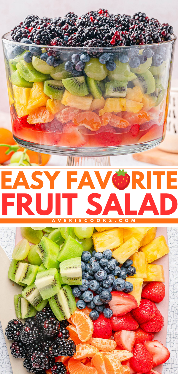 A glass trifle bowl filled with layered fruit salad including blackberries, blueberries, kiwi, pineapple, oranges, and strawberries, with a platter of the same fruits beside it.