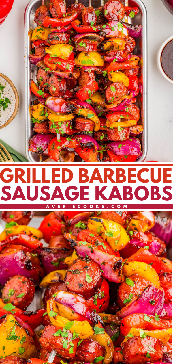 Tray of grilled sausage kabobs with red onions and bell peppers, garnished with chopped herbs, shown up close and from above.