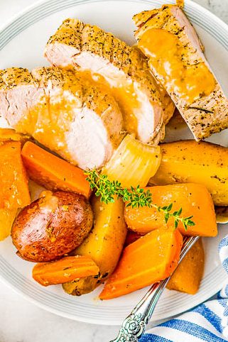 Slow Cooker Pork Loin - Tender, juicy pork loin is slow cooked with hearty vegetables for a complete and EASY meal! Reminiscent of a hearty and rustic recipe, yet fancy enough for a special dinner or holiday entertaining!