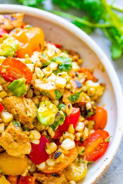 Grilled Chicken and Corn Salad -  An EASY salad that’s ready in 15 minutes and you won’t be able to stop eating it!! Tender chicken, juicy corn, crisp bell peppers and tomatoes, creamy avocado, cilantro, and fresh lime juice for the WIN!!